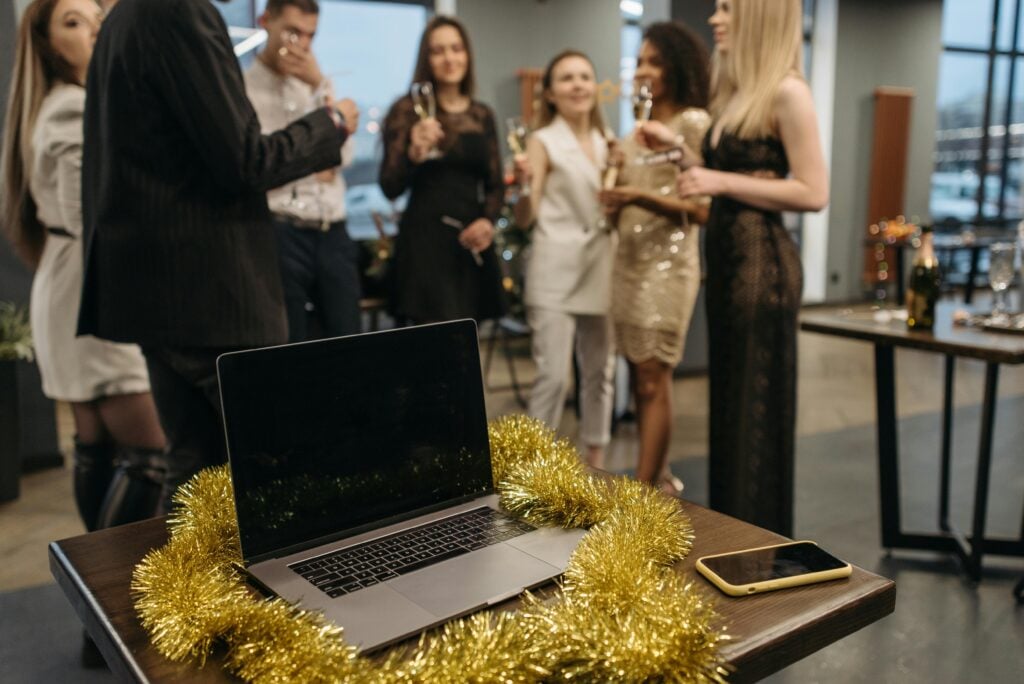 Employees celebrating a work anniversary with laptop in foreground