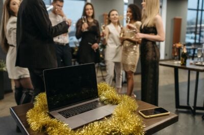 Employees celebrating a work anniversary with laptop in foreground