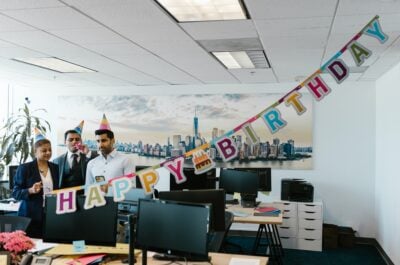 Group of people preparing to celebrate a birthday in the office