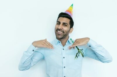 Office worker in birthday hat making a pose for the camera