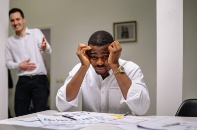Employee with head in hands looking stressed
