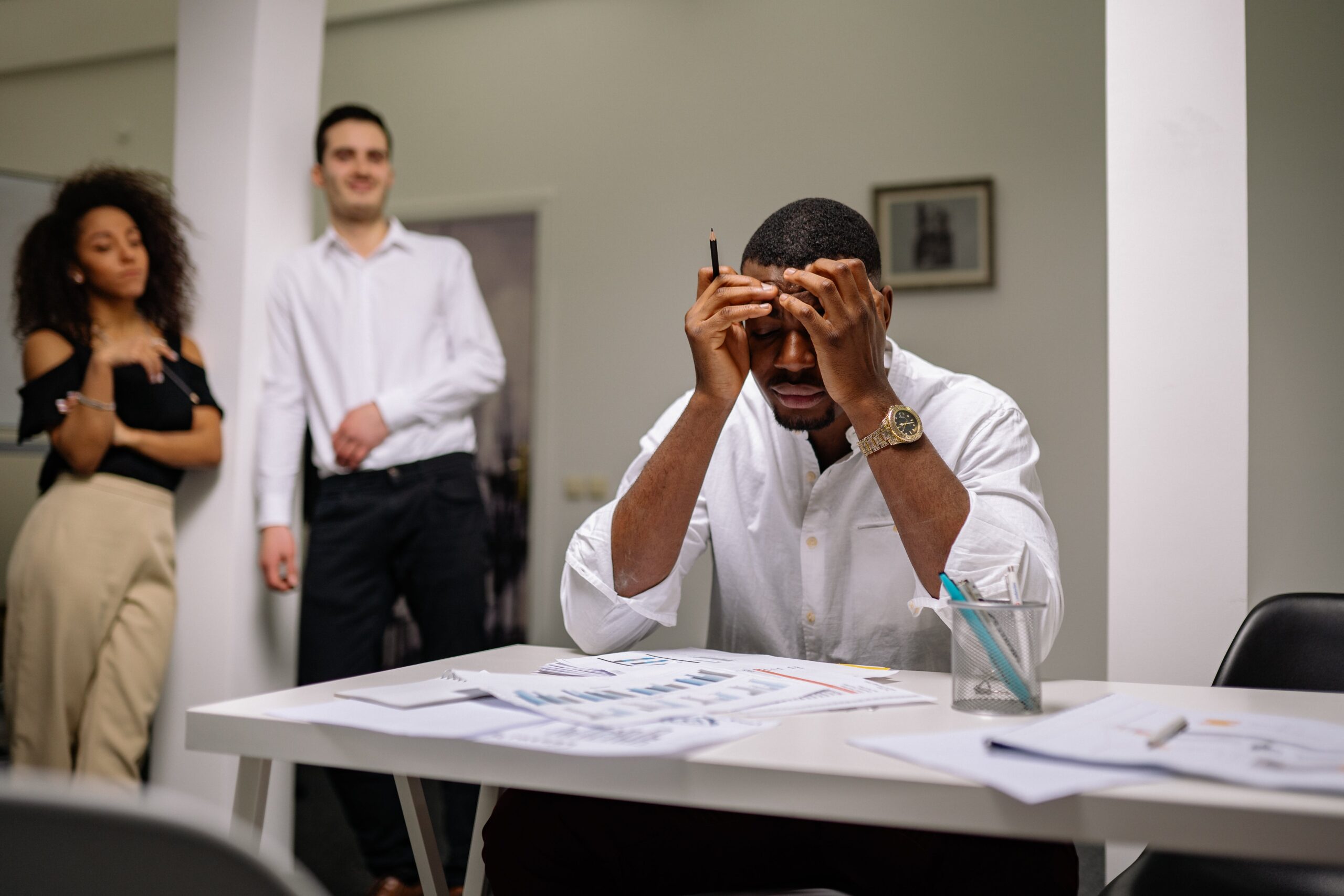 Stressed employee contemplating leaving at desk