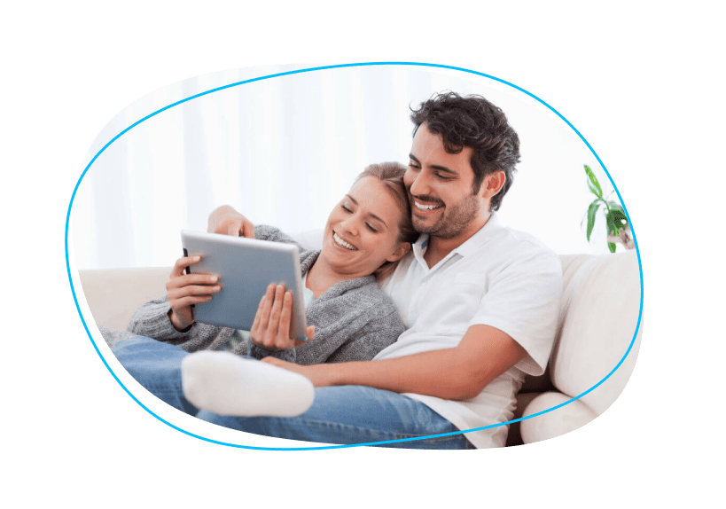 Couple relaxing together in a chair with an ipad