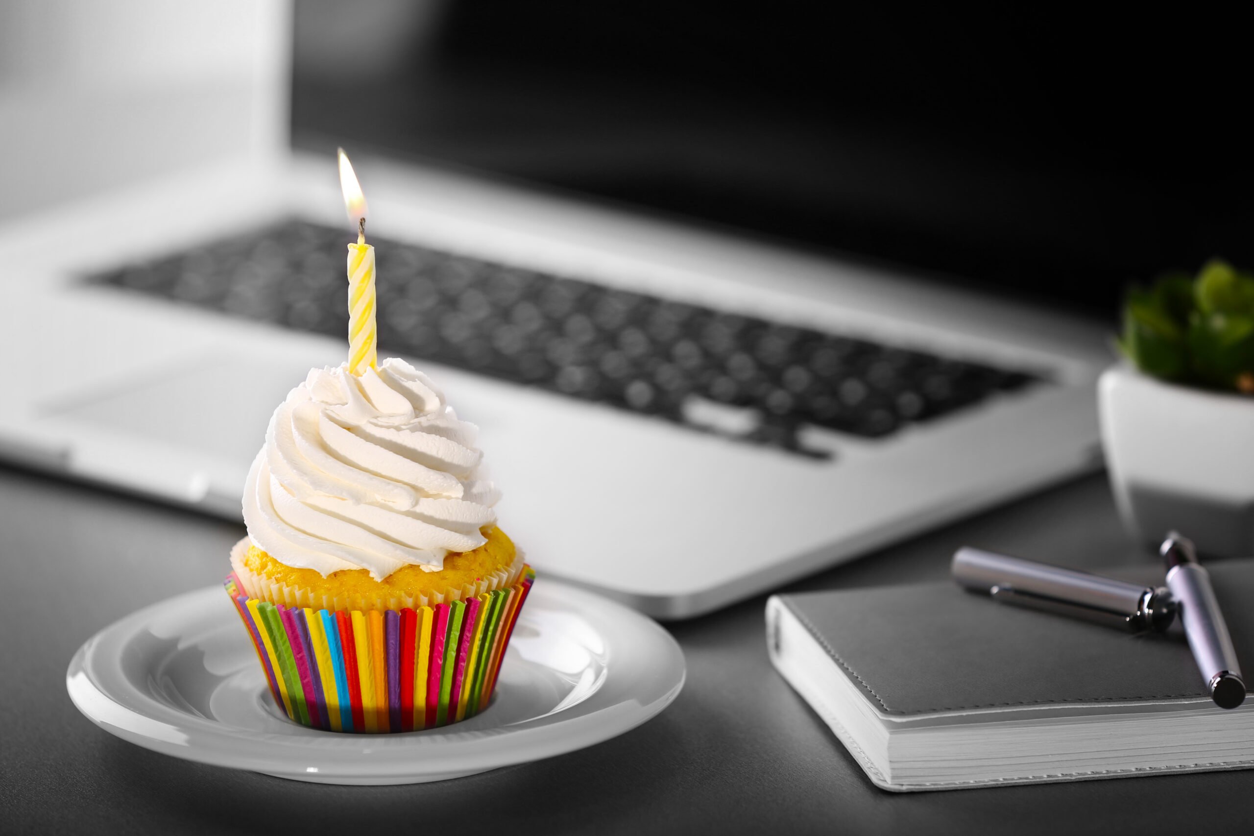Work anniversary cupcake by laptop