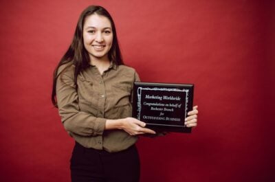 Woman holding an employee recognition award