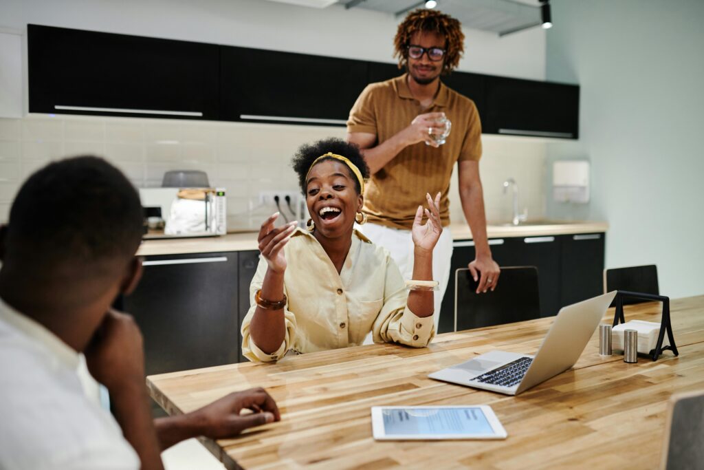 People laughing around table in office