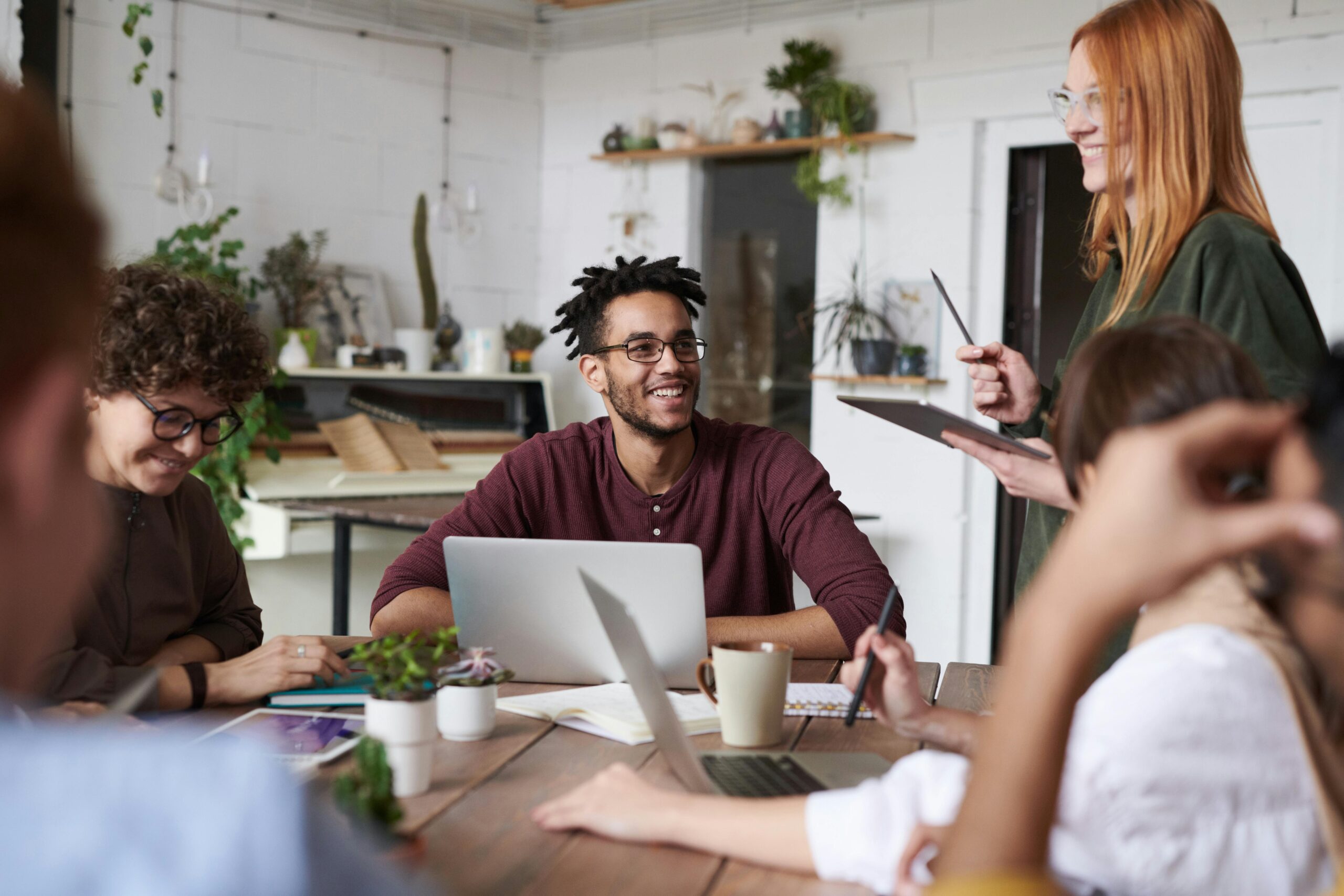 Employee smiling and talking with members of staff