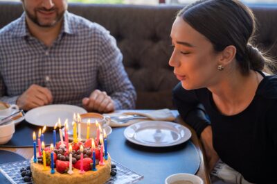 Friend blowing out candles on a birthday cake