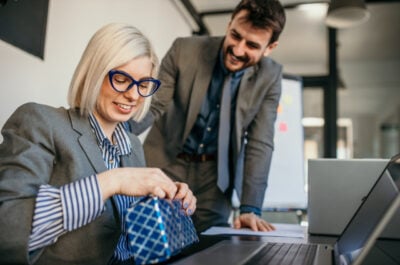 Woman opening present in the office