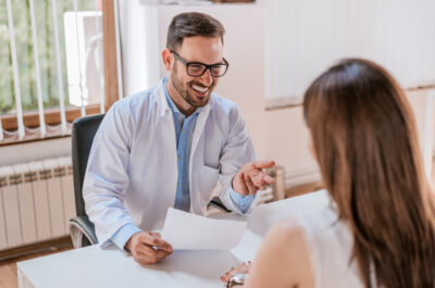 Doctor talking and laughing with his patient