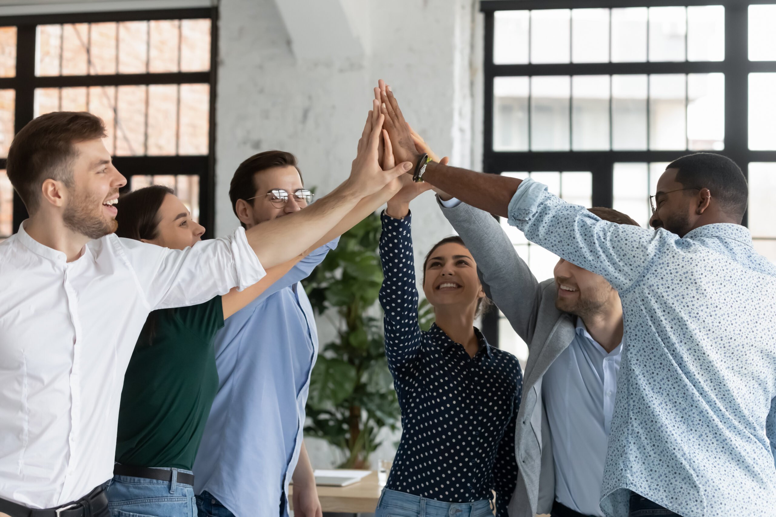 Entire team high fiving on Admin Professionals Day