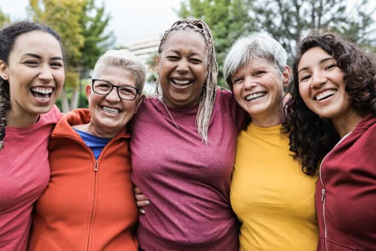 Group of women joining arms for Women's Day