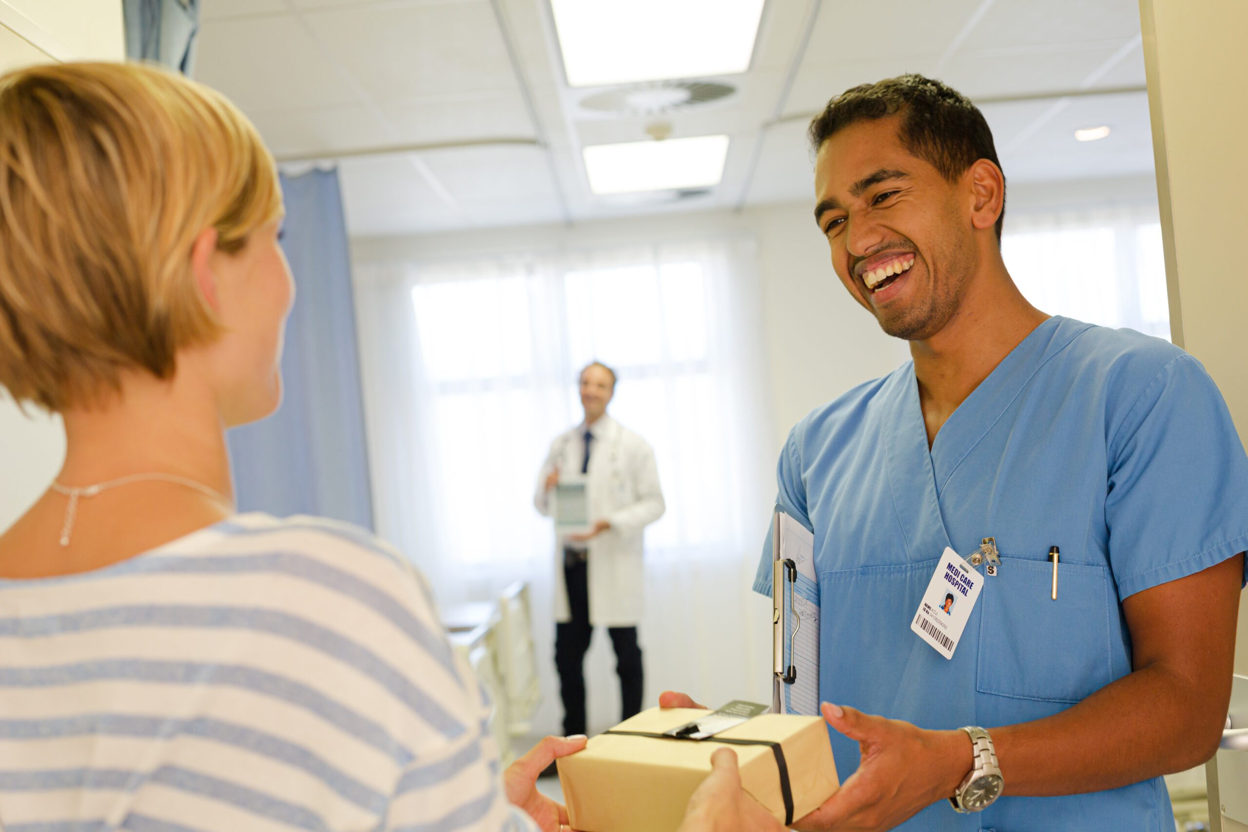 Nurse receiving thank you gift from person