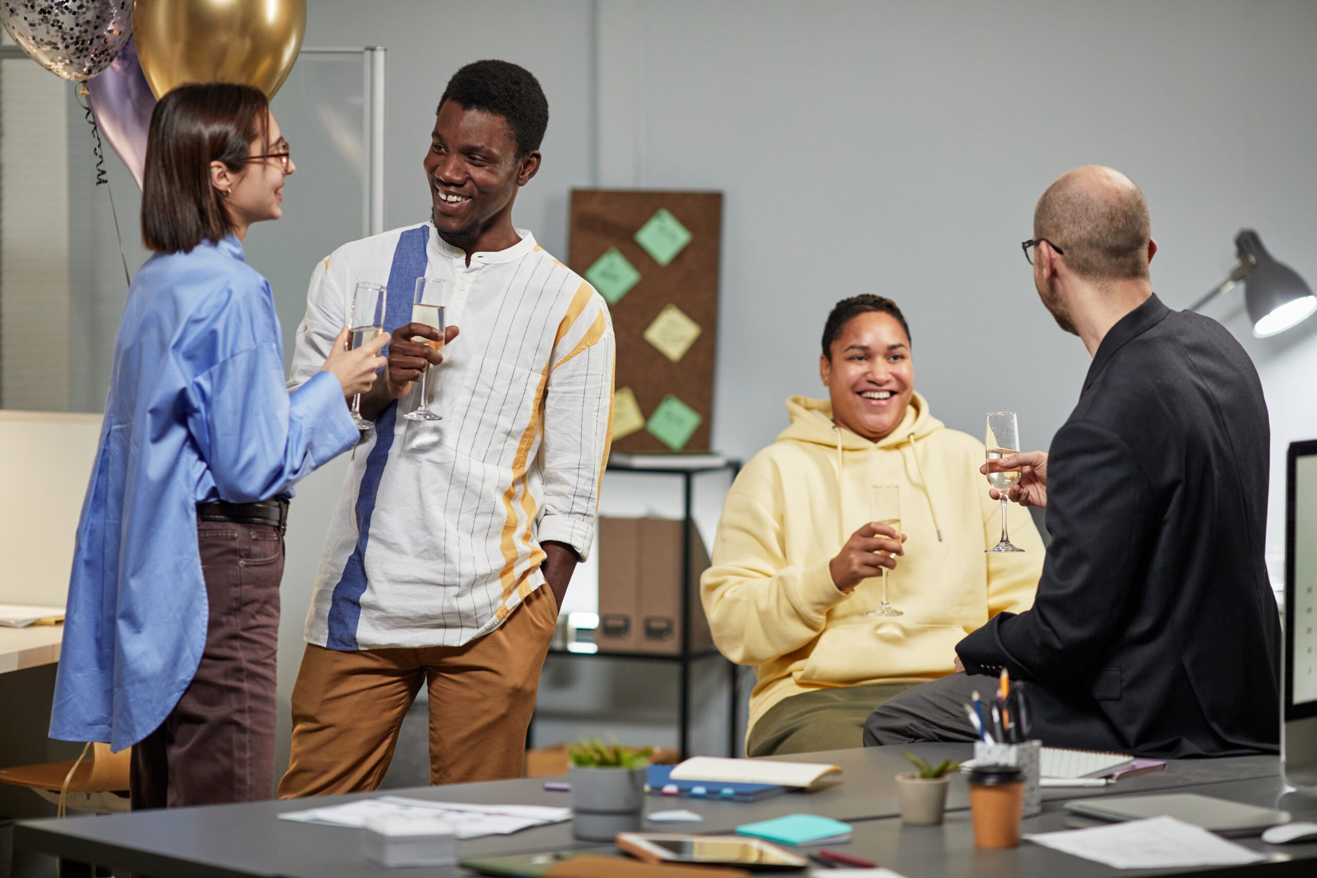 Group of people in office sitting around and talking after birthday