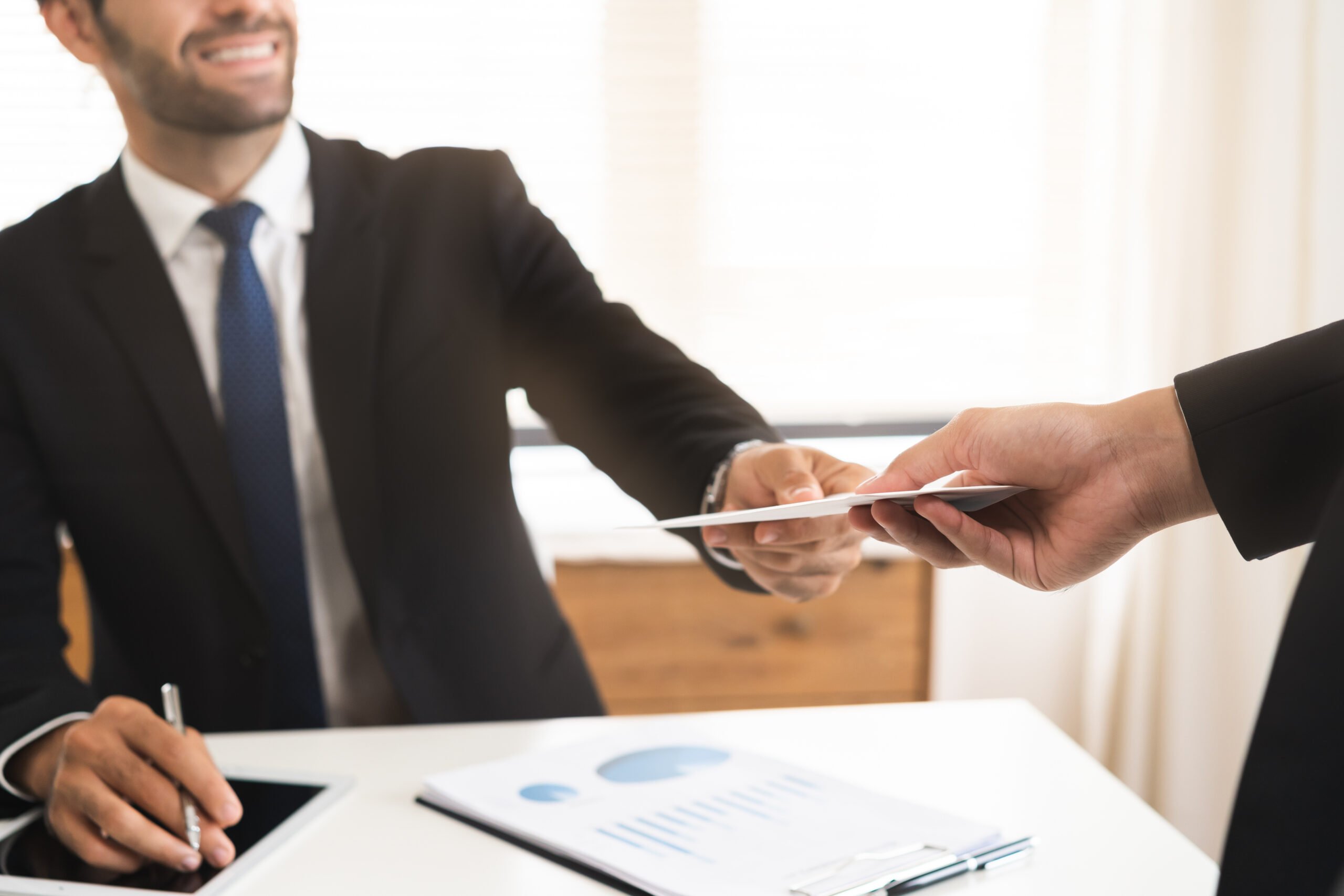 employee giving recognition letter in office