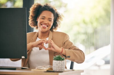 Person saying "thank you for the birthday wishes" with heart gesture