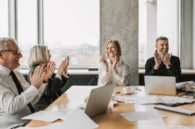 Employees clapping in a board room