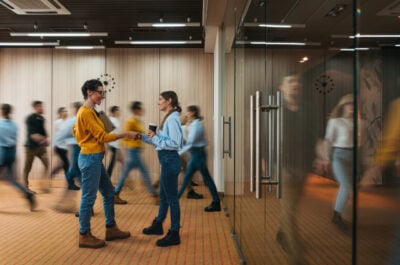 Employees walking around a busy hip office