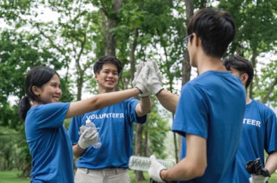 Earth Day volunteers cleaning up trash and high fiving