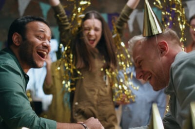 Two people laughing at funny birthday wishes