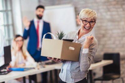 Person celebrating their retirement with box of office supplies