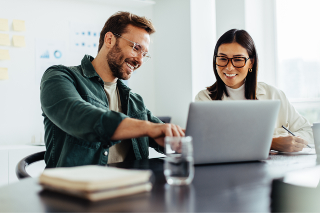 Smiling man answering what is an eCard by showing one on computer