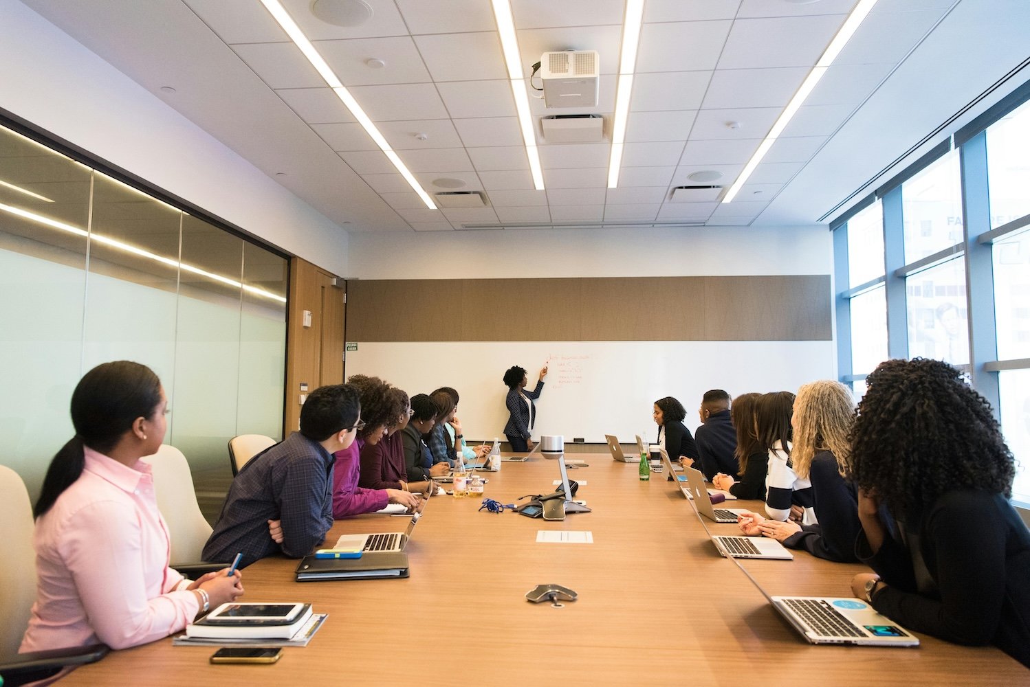 A group of employees sitting at a conference table working on an employee recognition program