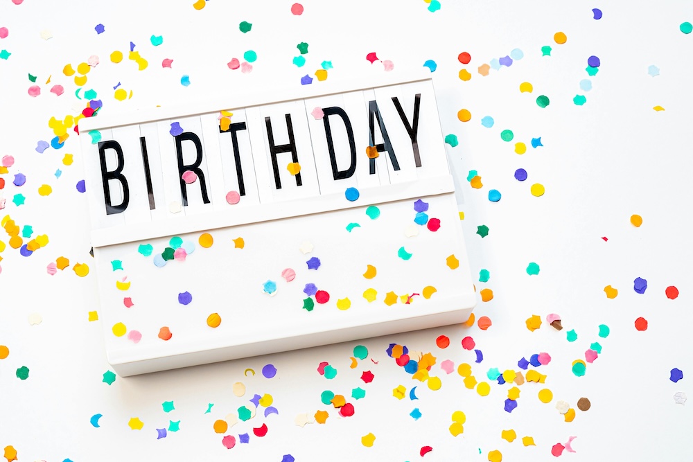 Confetti covers a white background; a white frame reads 