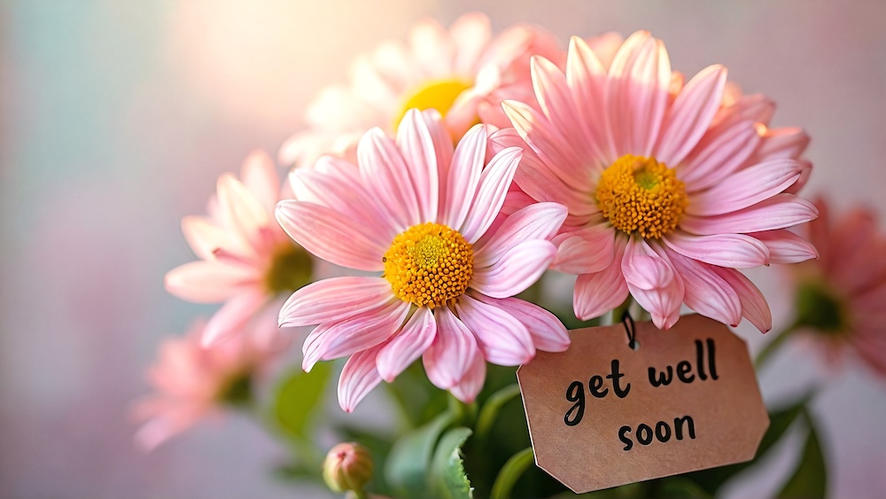 Bouquet of flowers with a get well soon group greeting card