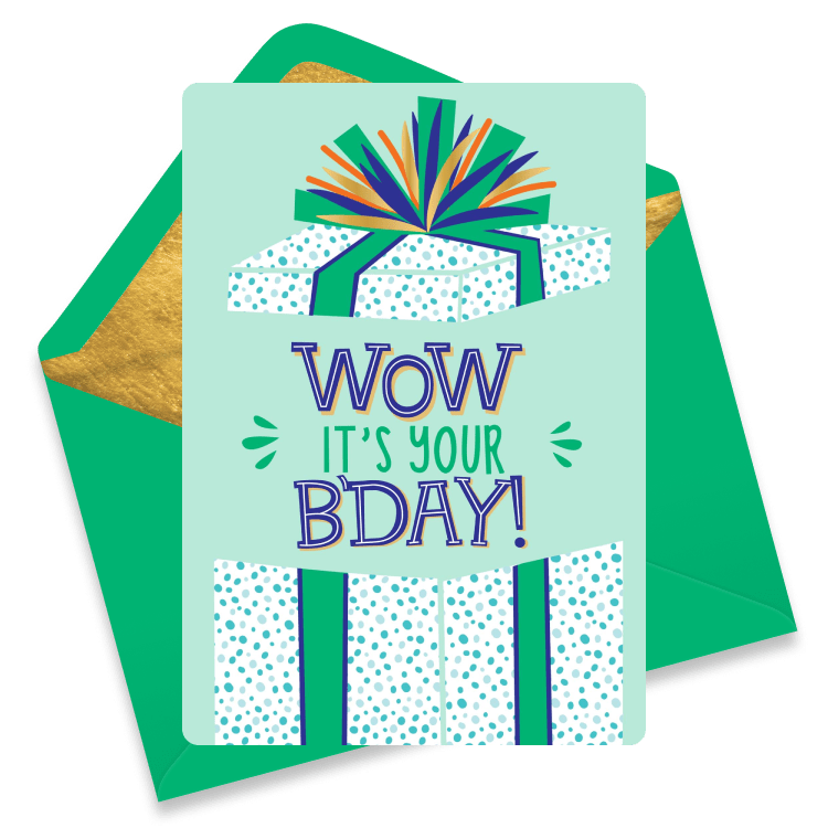 A birthday gift box wrapped in a green bow. The top of the box is popping off and 