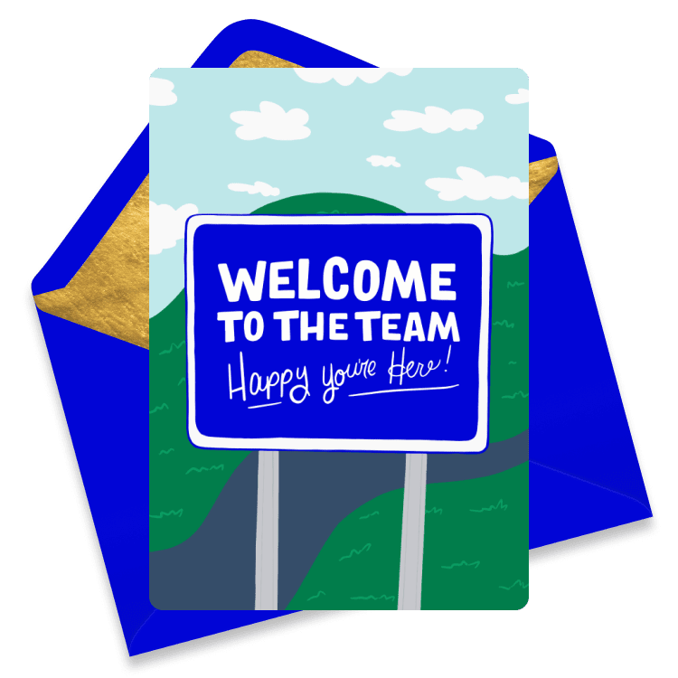 Bright eCard with a road sign reading 'WELCOME TO THE TEAM Happy you're Here!' set against rolling hills and a blue sky with clouds.