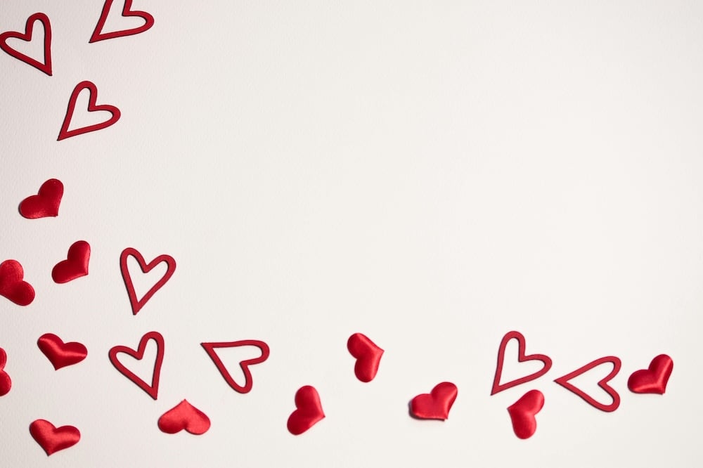 Embossed red hearts decorating a pale beige background